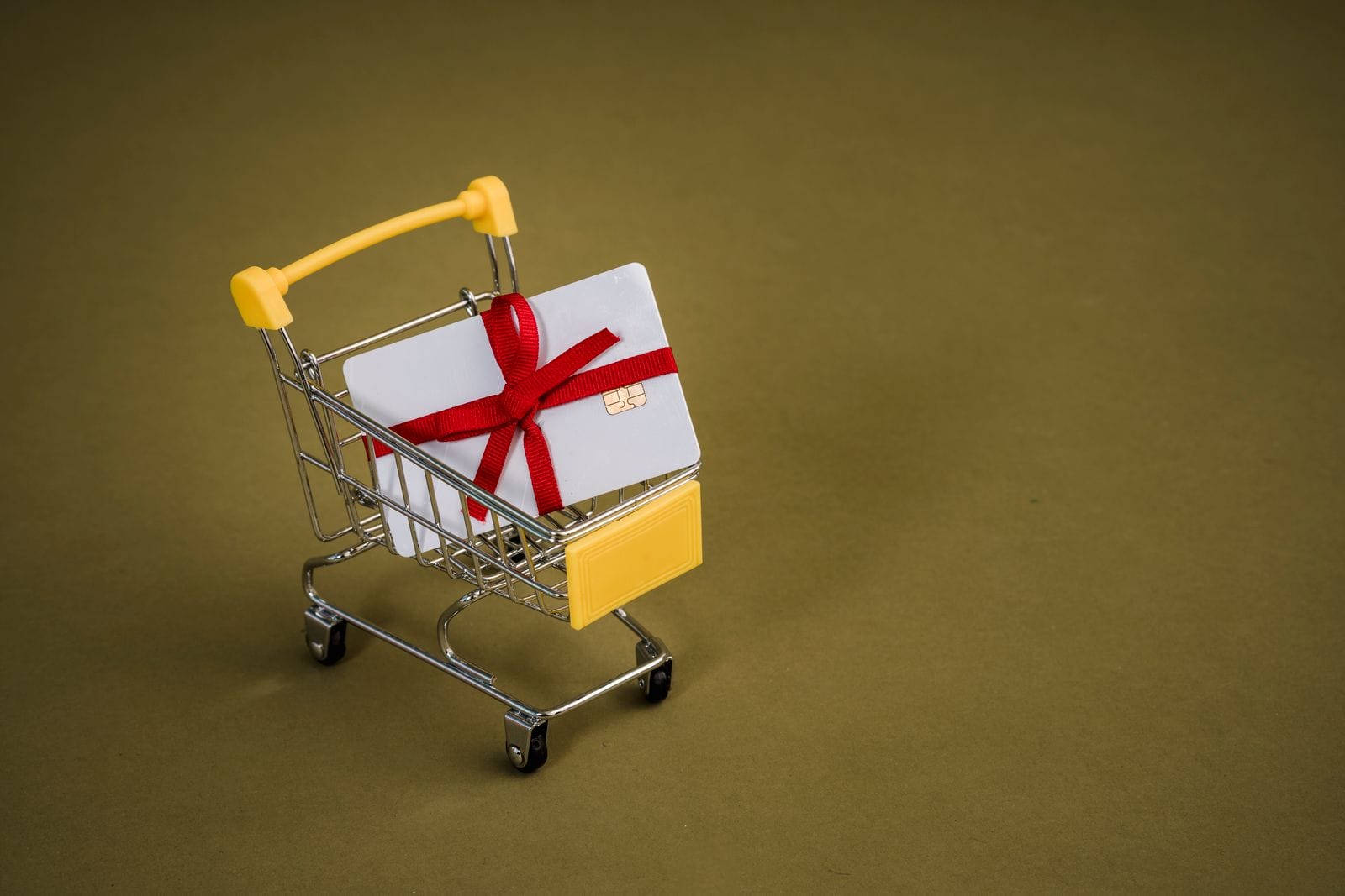 Gift card with red bow in a small shopping cart